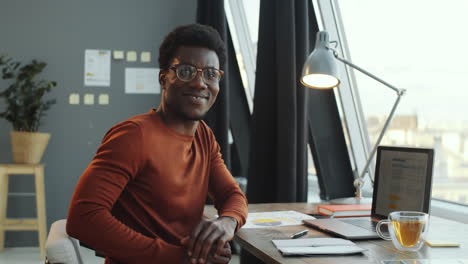 Happy-Black-Businessman-Posing-for-Camera-in-Office